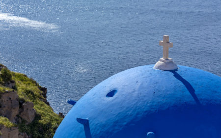 The iconic blue domes of Santorini architecture! Photo by C. Drazos